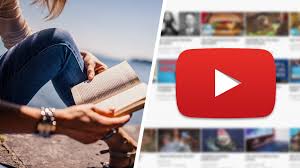 A person holding an open book with a YouTube logo overlay.