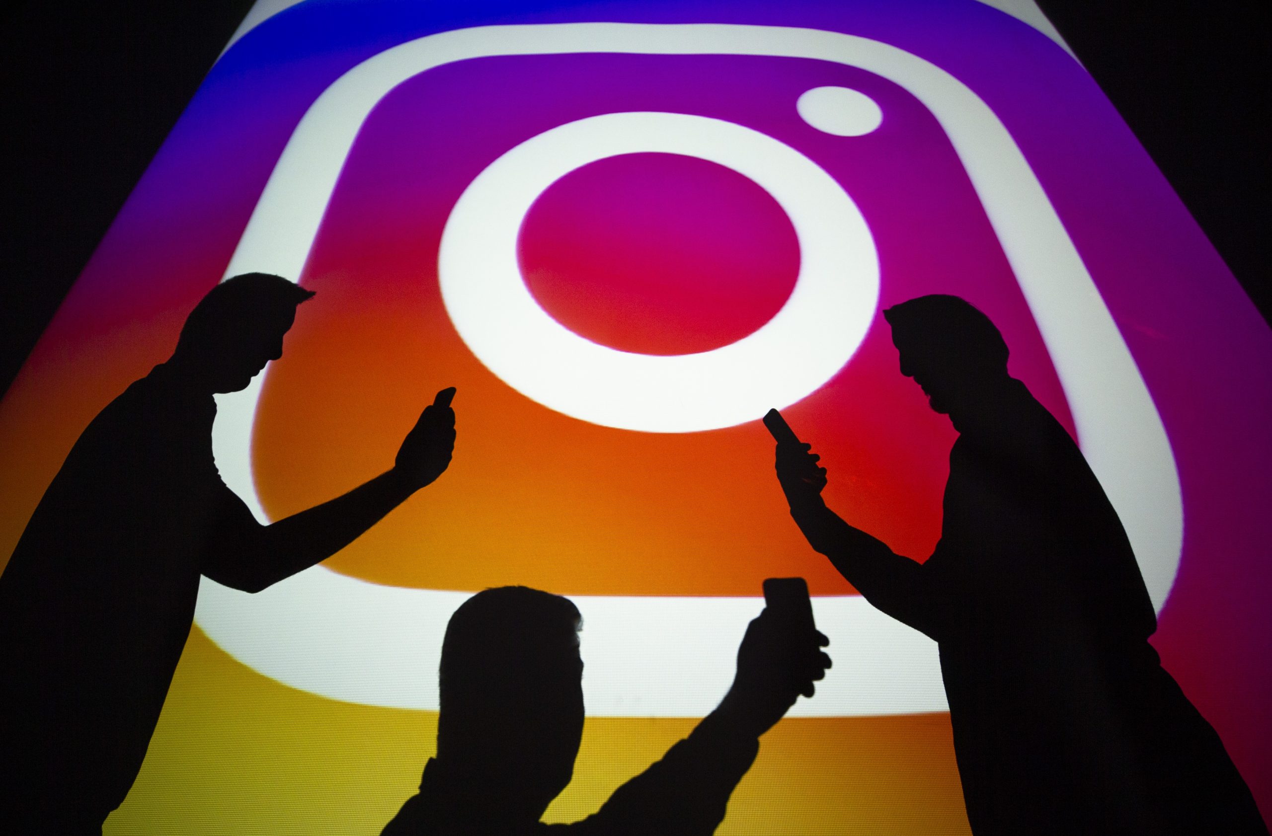A person using a smartphone to browse Instagram.