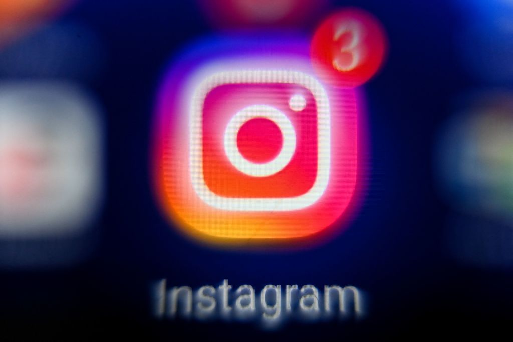 A person holding a smartphone with the Instagram app open, showing follow requests.